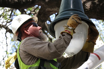 Austin Energy crew member installs lighting in UT's West Campus